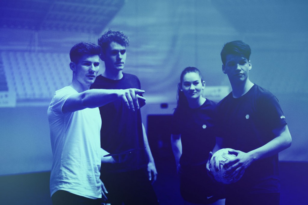 Three adult players getting instructions from a skills.lab coach during a free trial for adults