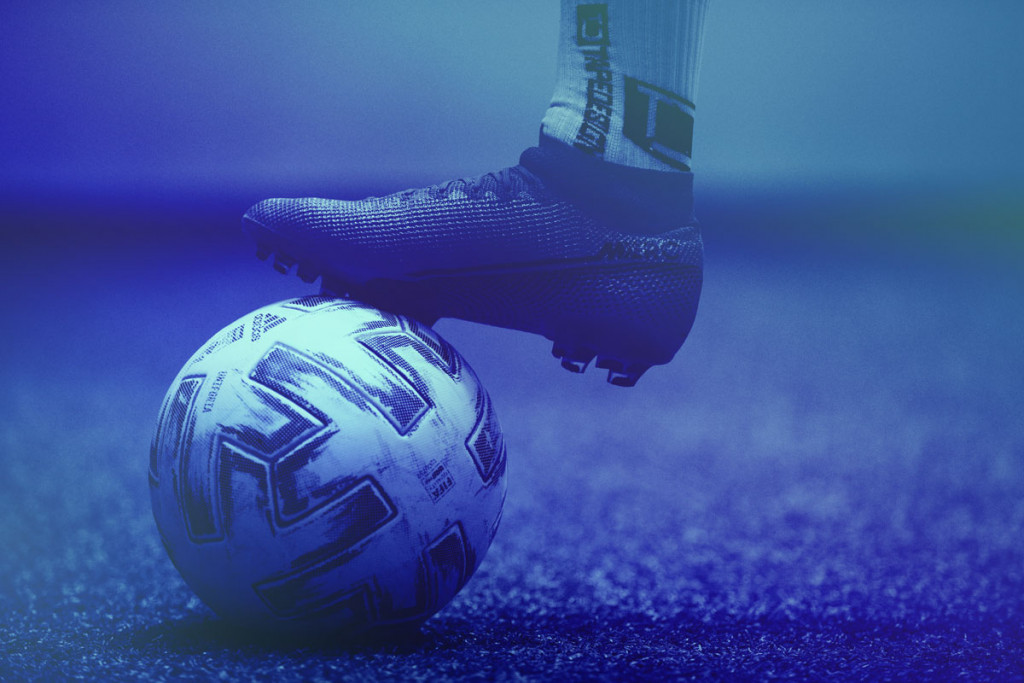 Detail shot of a ball and a player's foot